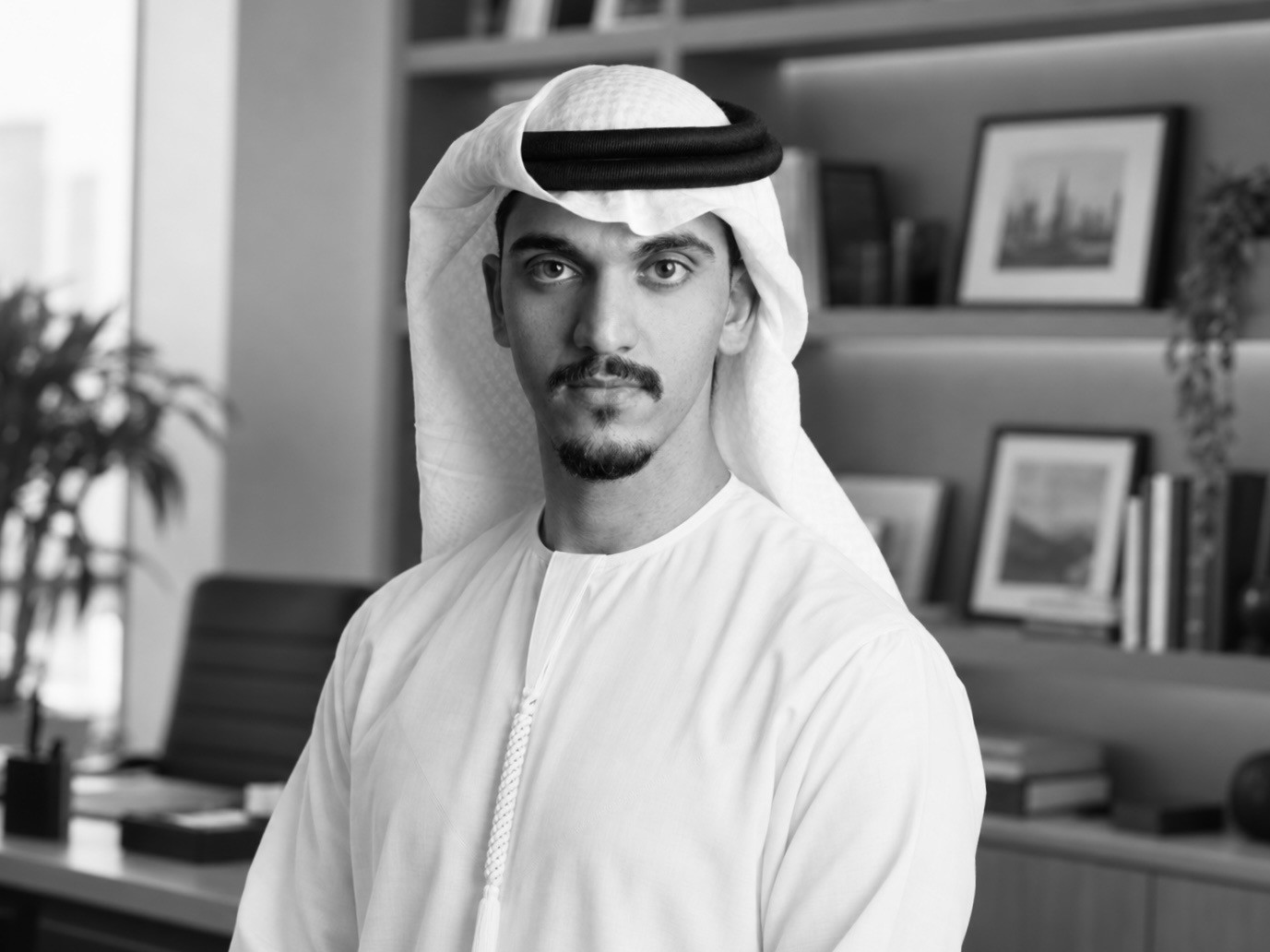 Black-and-white portrait of Ali Al Nowais in a white kandura and ghutra