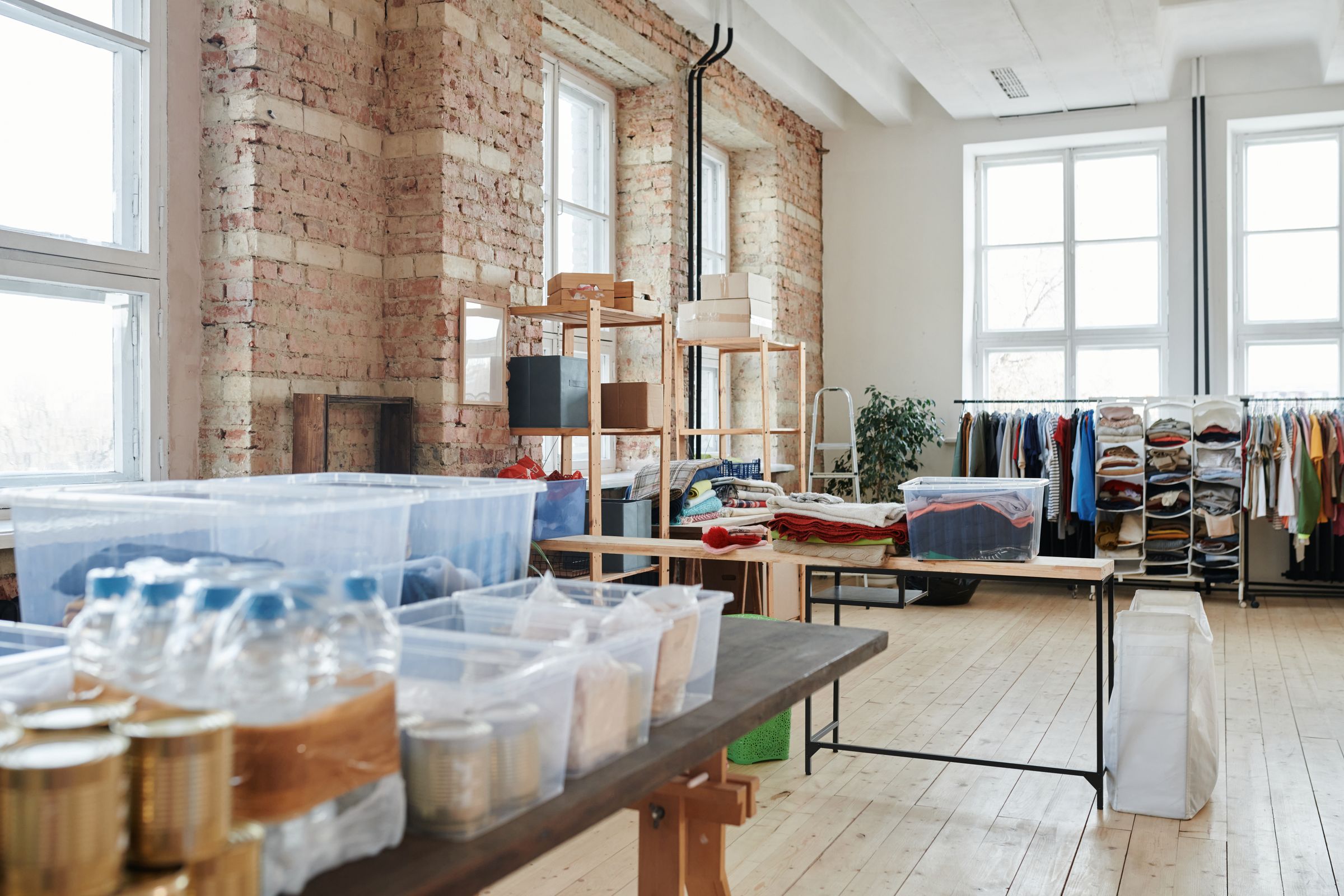 Fashion products, clothing rails, and organised fulfilment materials in a distribution workspace.