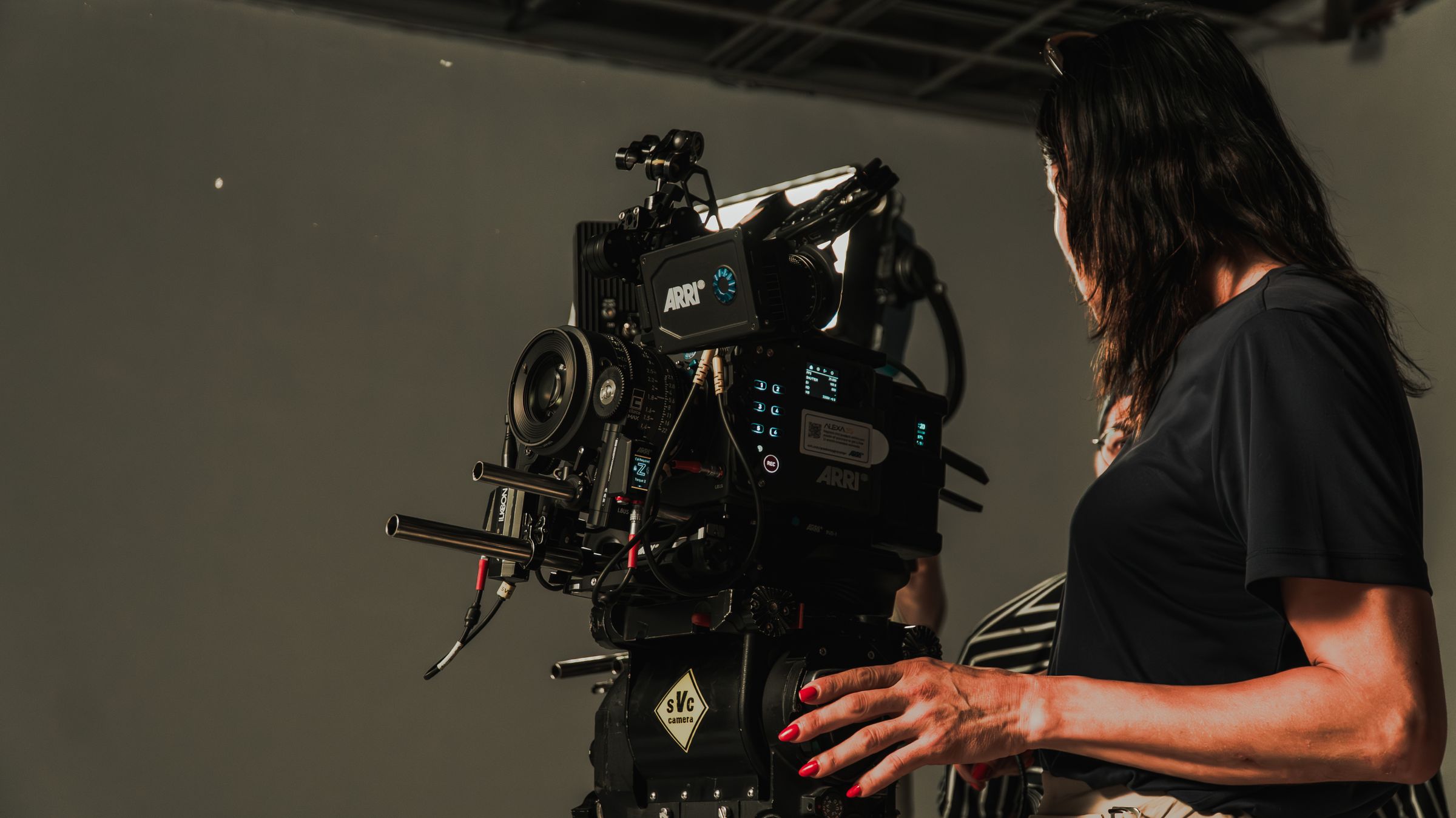 A professional camera crew operating a cinema camera on an active production set.