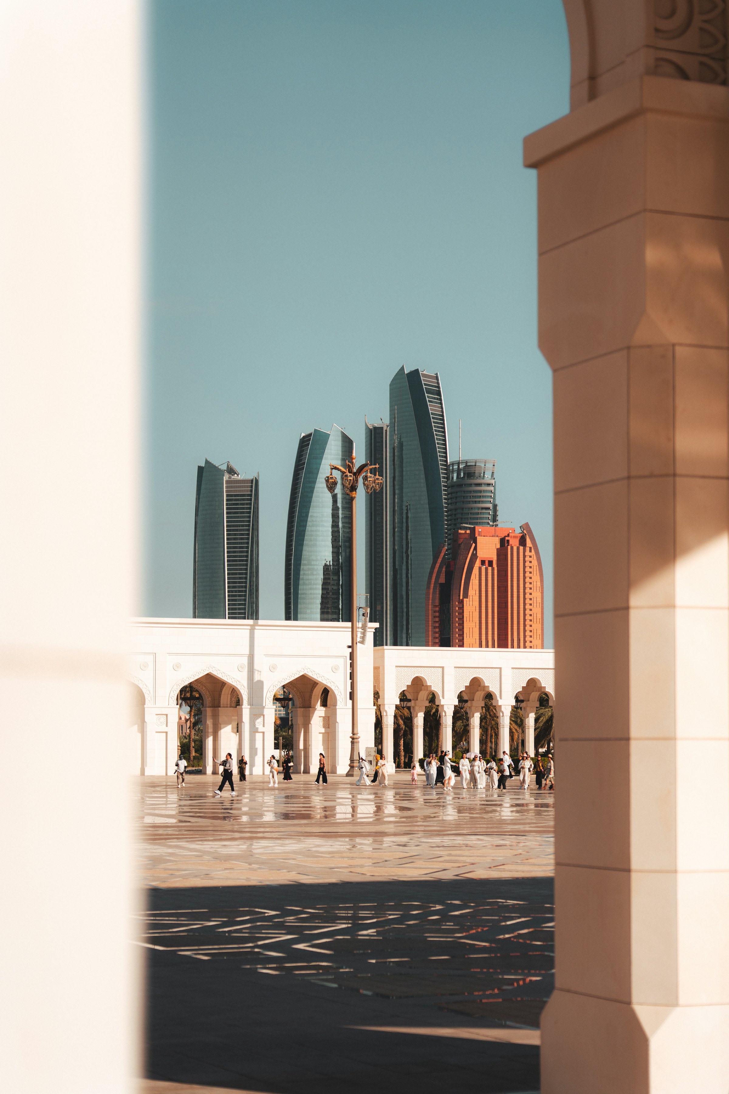 A real architectural view across Abu Dhabi, framed by Qasr Al Watan with the city skyline beyond.